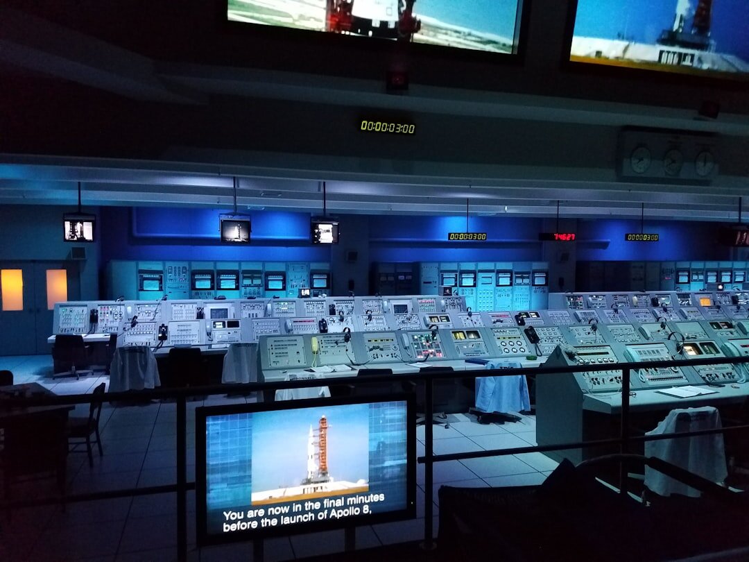Dark video production control room with glowing screens